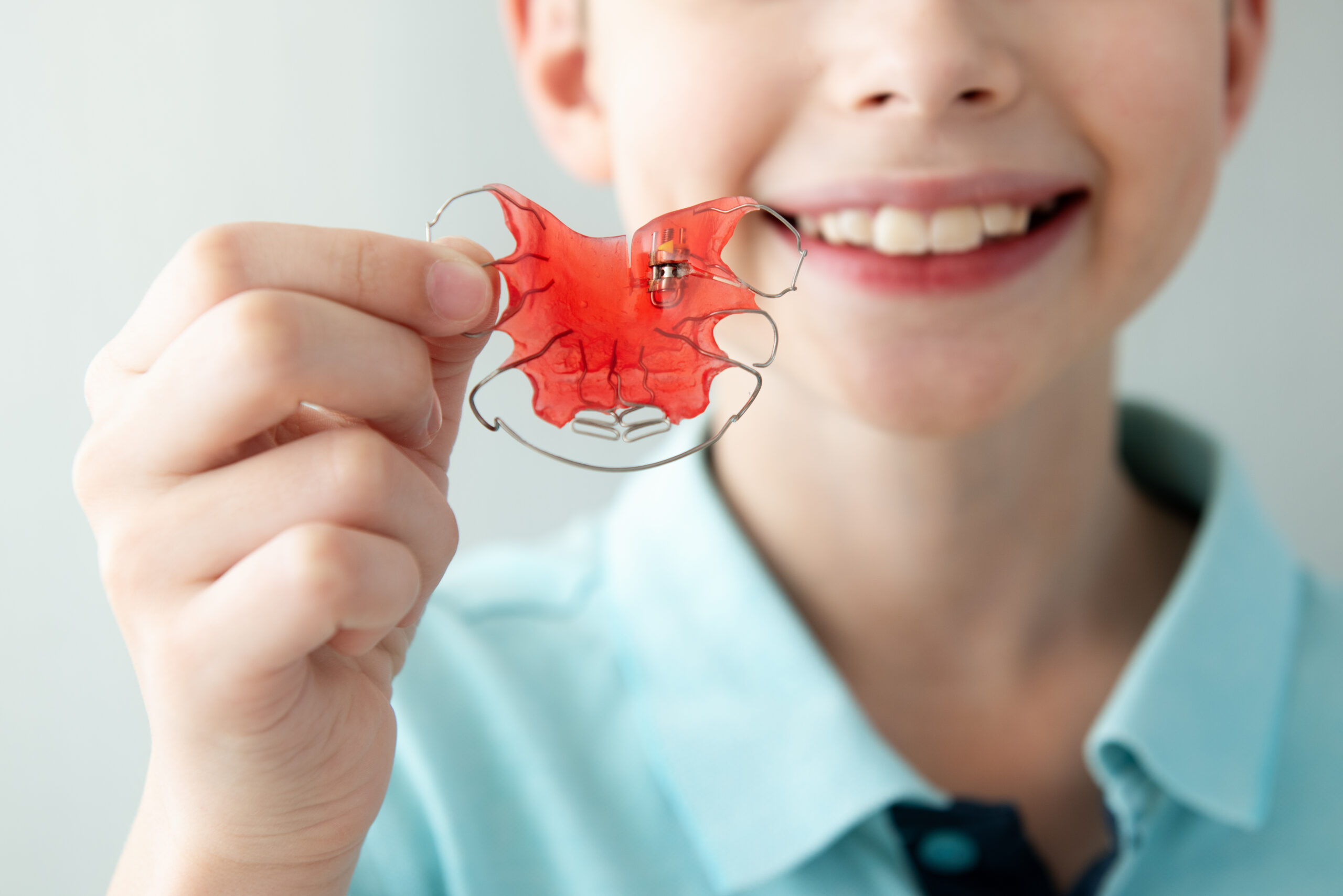 A child holding a retainer.